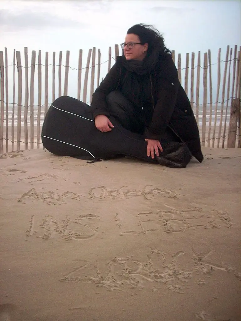 Anja am Strand mit Gitarre